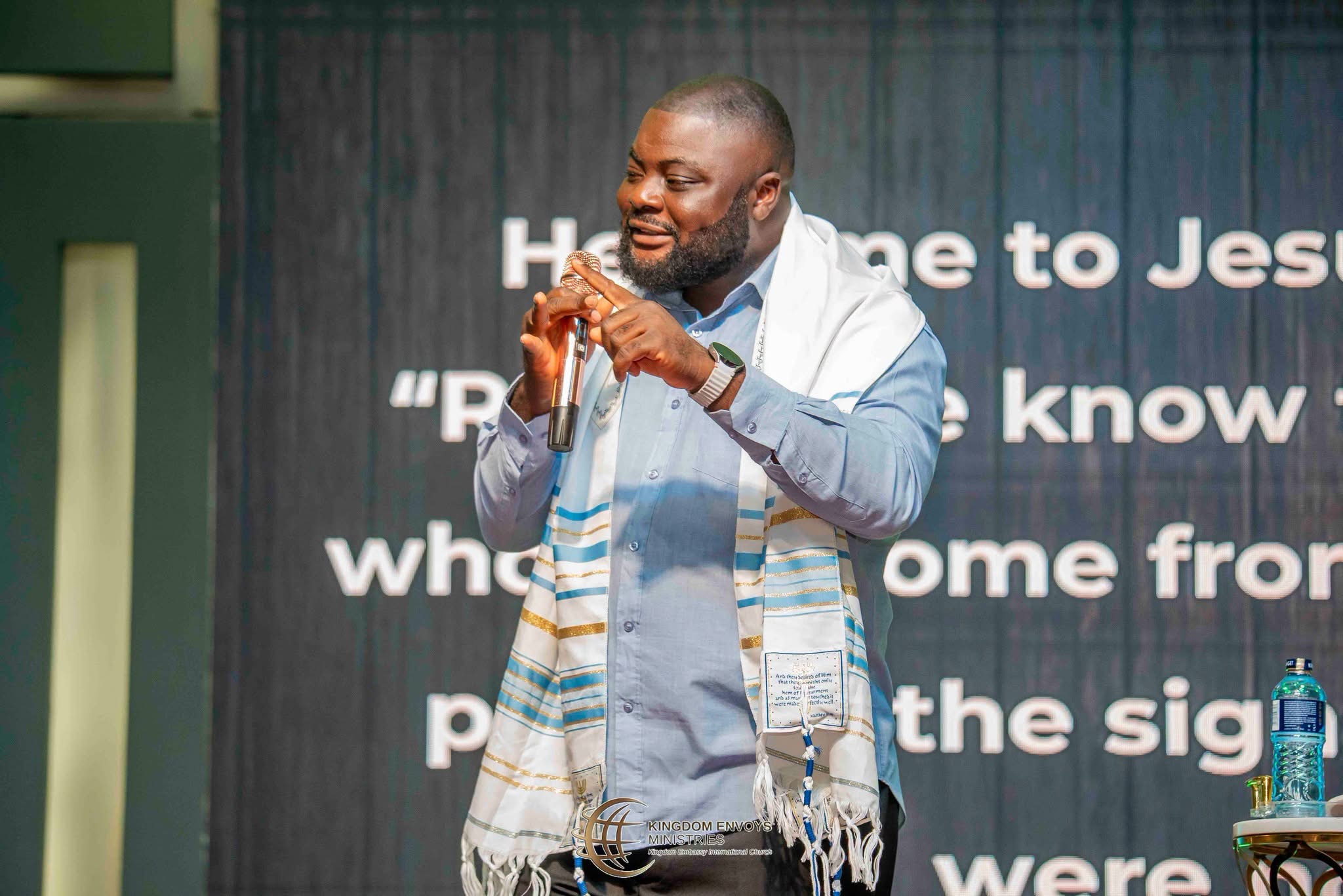 Samuel Folabi ministering on stage with a microphone